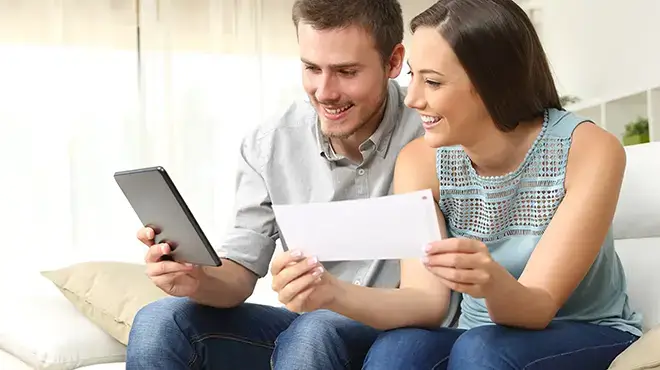 couple on couch holding cell phone